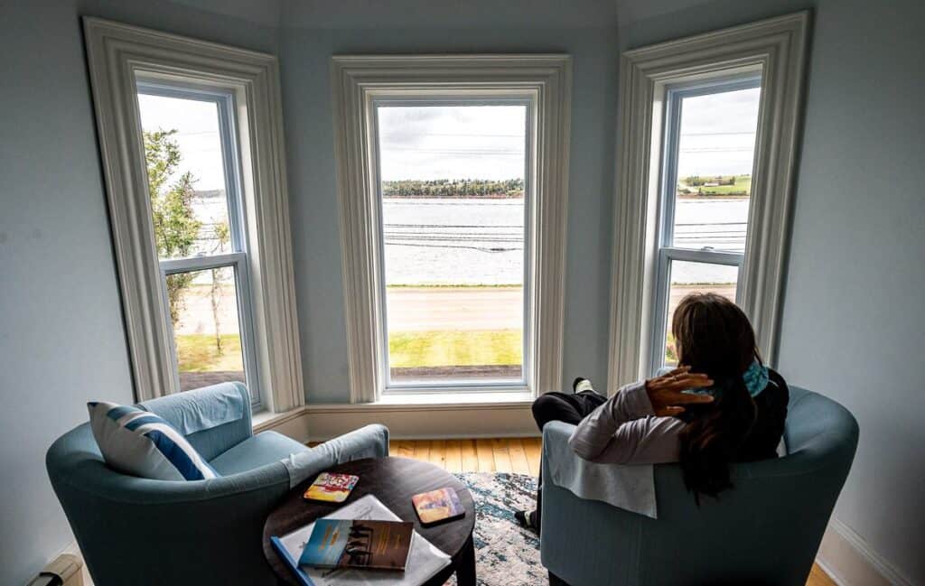 A reading nook with a view at Points East Coastal Inn in St. Peter Bay, Prince Edward Island