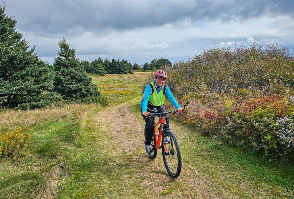 My friend rides a bike on the Talaqatik Trail in the Greenwich section of Prince Edward Island National Park