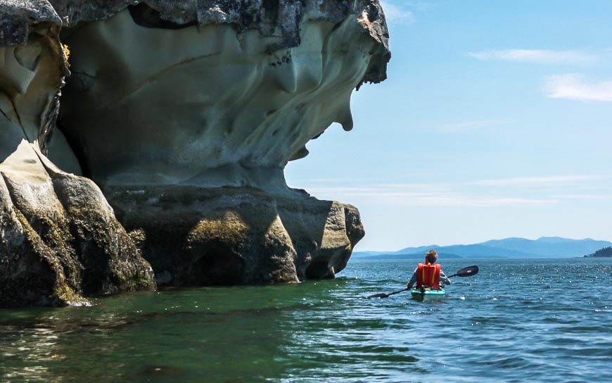 Kayaking past gargoyle looking rock formations