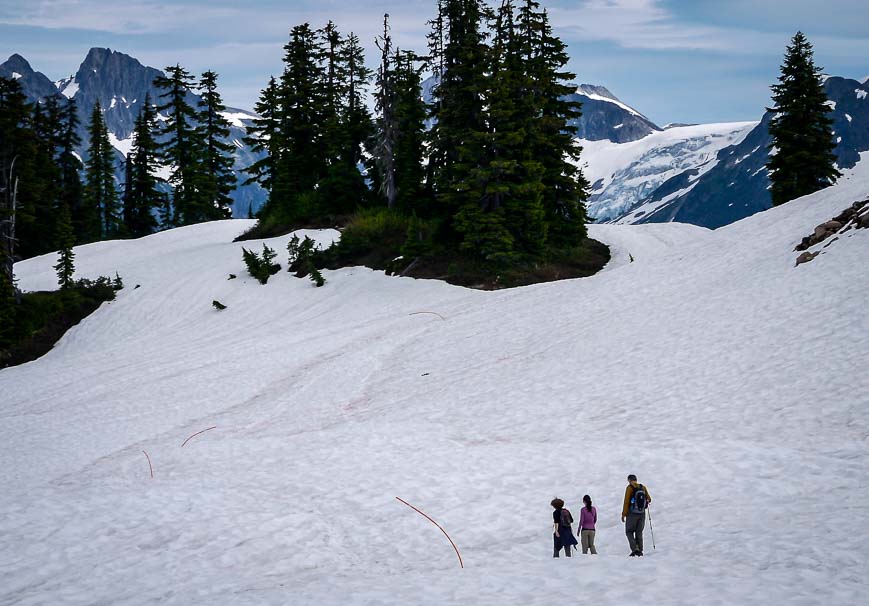 Hikers crossing the snowfields on route to Elfin Lakes