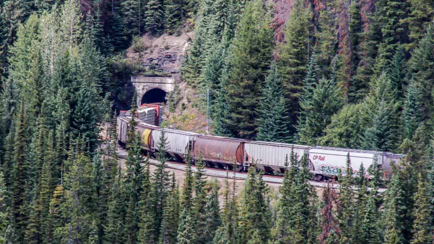 Looking at a train going through one of the Spiral Tunnels from the highway viewpoint in Yoho