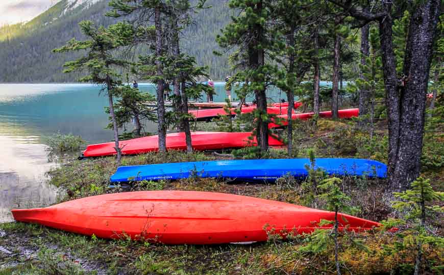 Colourful canoes lined up along the shores at the Coronet Creek Campground