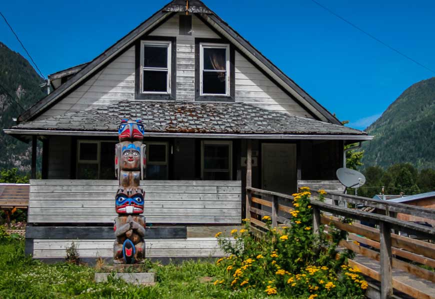 Totem pole in front of private home in Bella Coola
