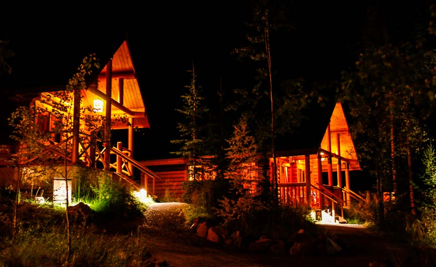 Well lit walking paths with inviting cabins at night