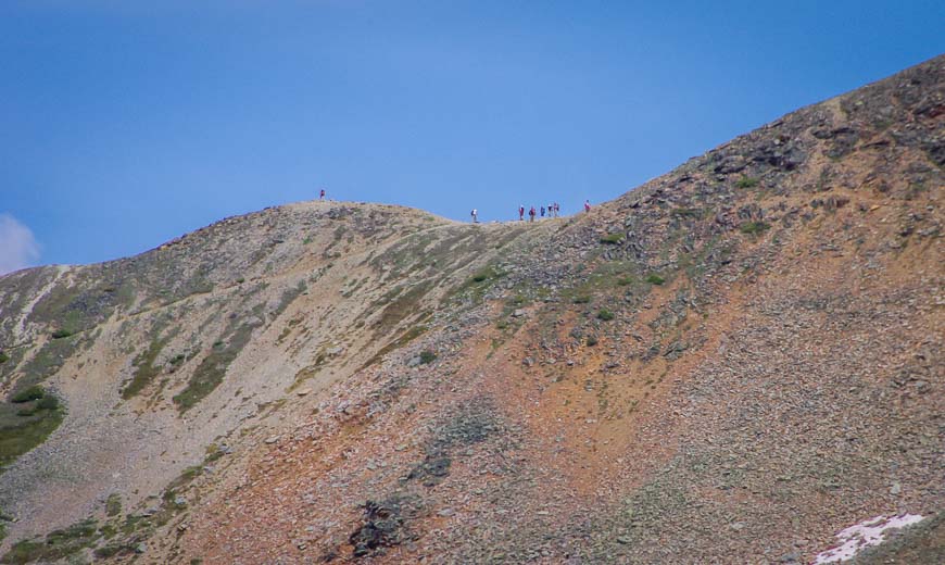 Looking up at the hikers on the saddle at Wiwaxy Gap