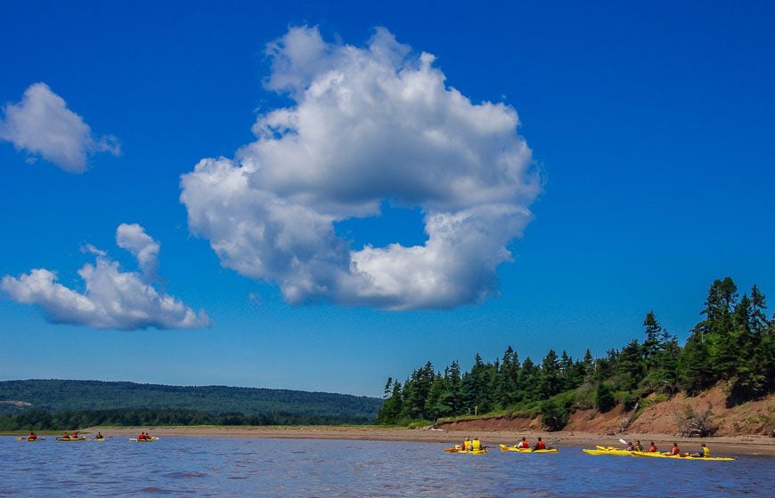 Kayaking Hopewell Rocks towards the donut shaped cloud