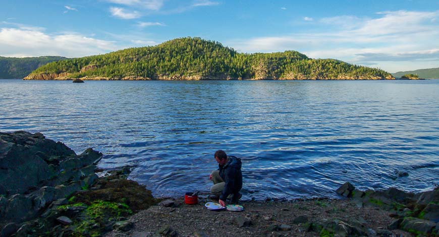 Doing dishes with a view of Ile St. Louis lit up in the sun after dinner; its one of 7 islands in the fjord