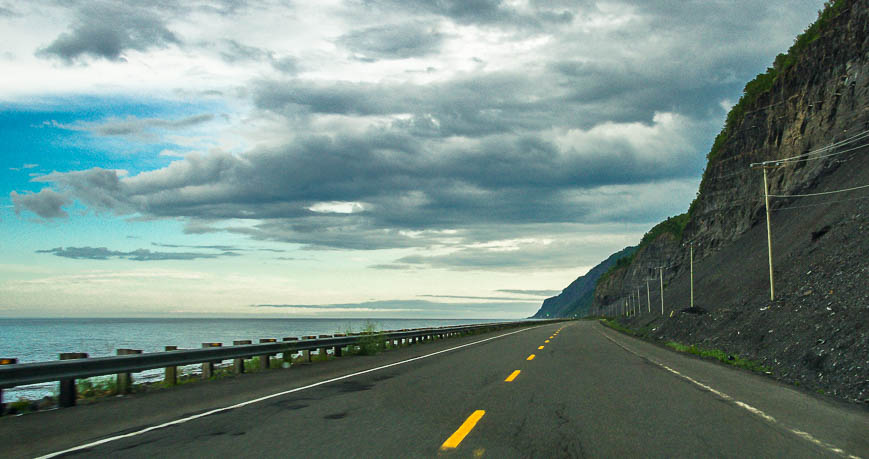 The road crawls along the base of the mountains on the Gaspe Peninsula 