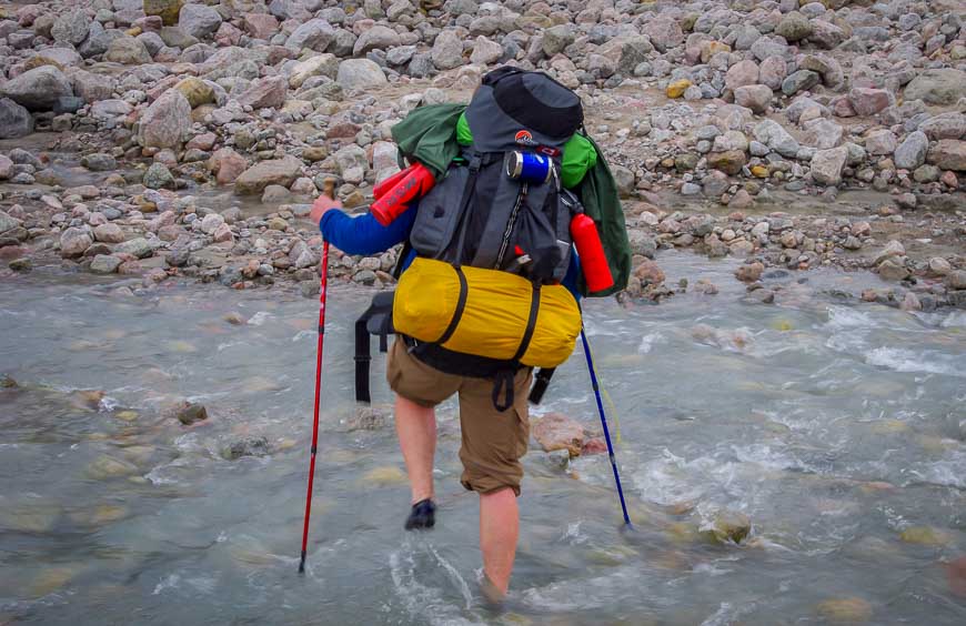 Fording an icy stream in Auyuittuq National Park