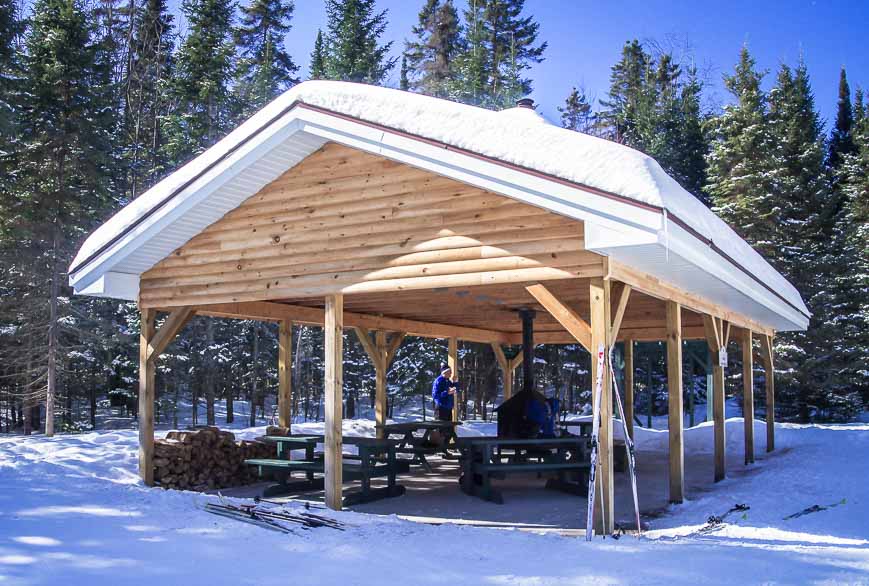 One of the open air warming shelters with a wood burning stove