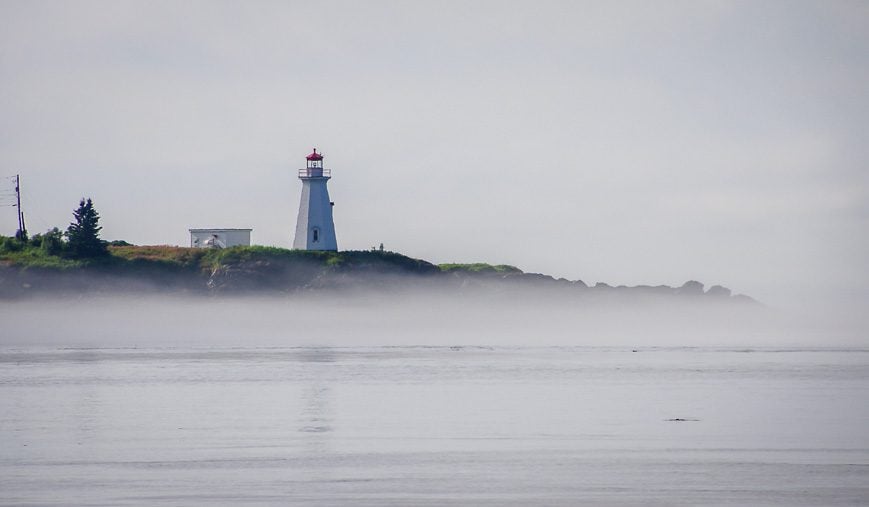 Lighthouse rising from the fog