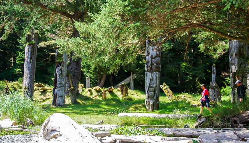 Walking past Memorial Poles on Ninstints Island