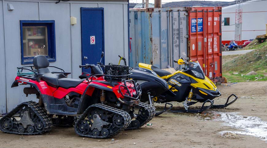 Snowmobiles in front yards in Iqaluit