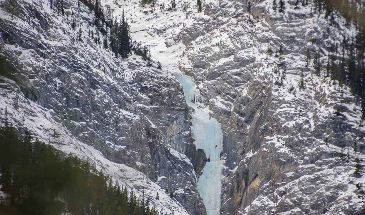 Ice climbers on a huge frozen waterfall on the north side of the Spray River in Banff