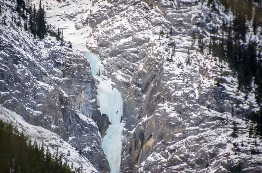 Ice climbers on a huge frozen waterfall on the north side of the Spray River