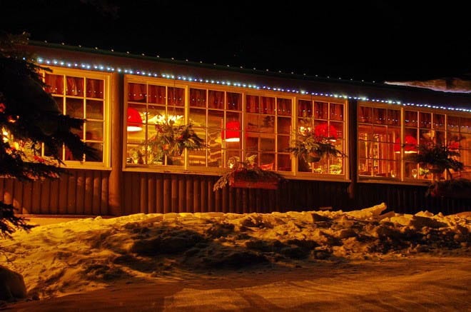 The dining room lit up at night - Storm Mountain Lodge