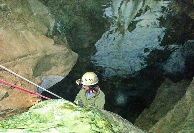 Rappelling into a cave near Canmore