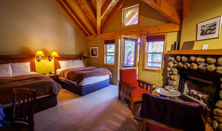 Our bedroom in Buffalo Mountain Lodge, featuring a wood-burning fireplace and private deck