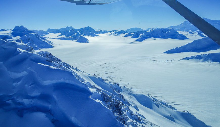Mountains look like islands in the field of ice seen on a Kluane National Park flightseeing tour