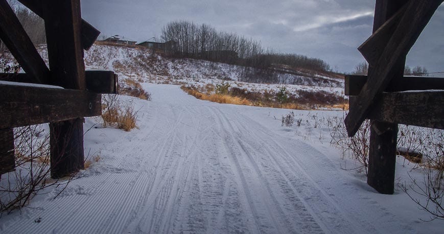 Cross country ski trails head under a big wooden trestle bridge in Camrose, Alberta