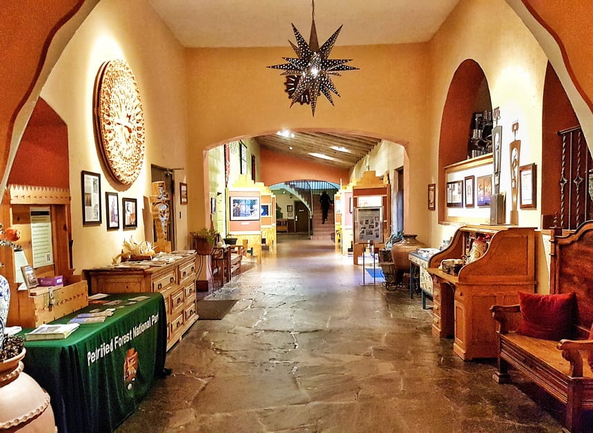 At La Posada Winslow Arizona get to the gardens, the art gallery and some of the bedrooms via an art-filled walk down a corridor