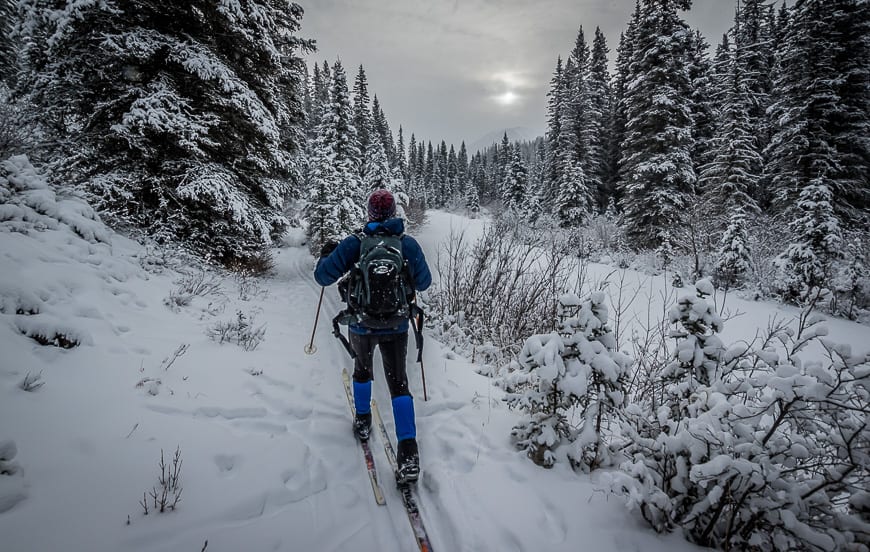 Skiing alongside the river beyond the lodge