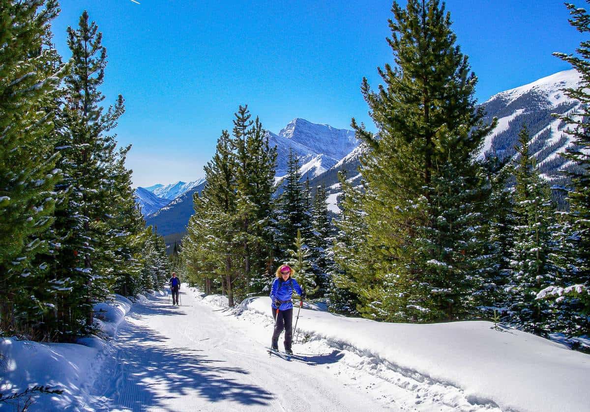 Skiing up to Skogan Pass with Nakiska Ski Resort in the background