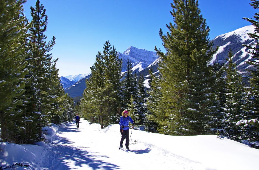 Skiing up to Skogan Pass with Nakiska Ski Resort in the background