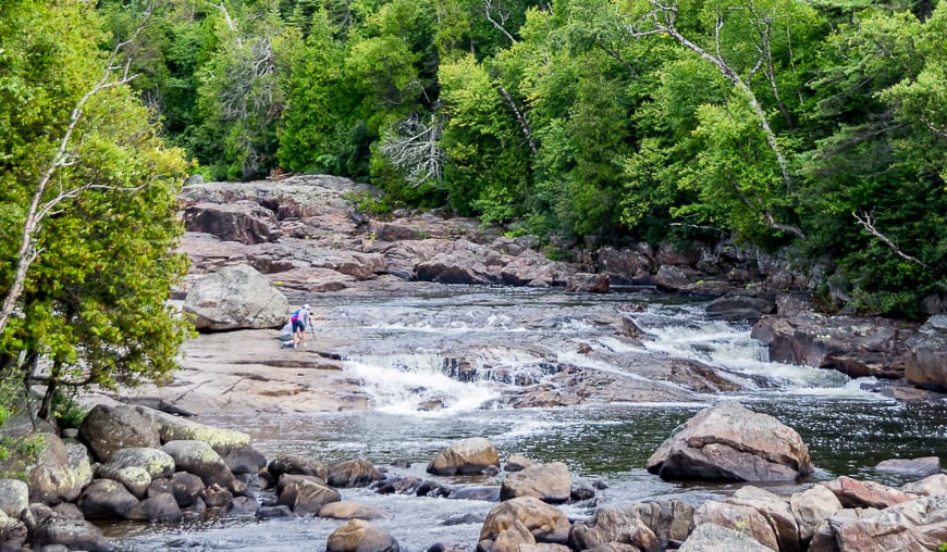 Watching a photographer at rock on the Sand River