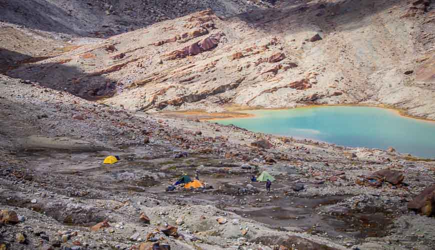 Camping near the beautiful robin egg blue lake on the spectacular Sierra Nevada del Cocuy trek