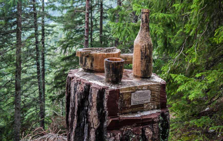 Fondue and a bottle of wine made of wood