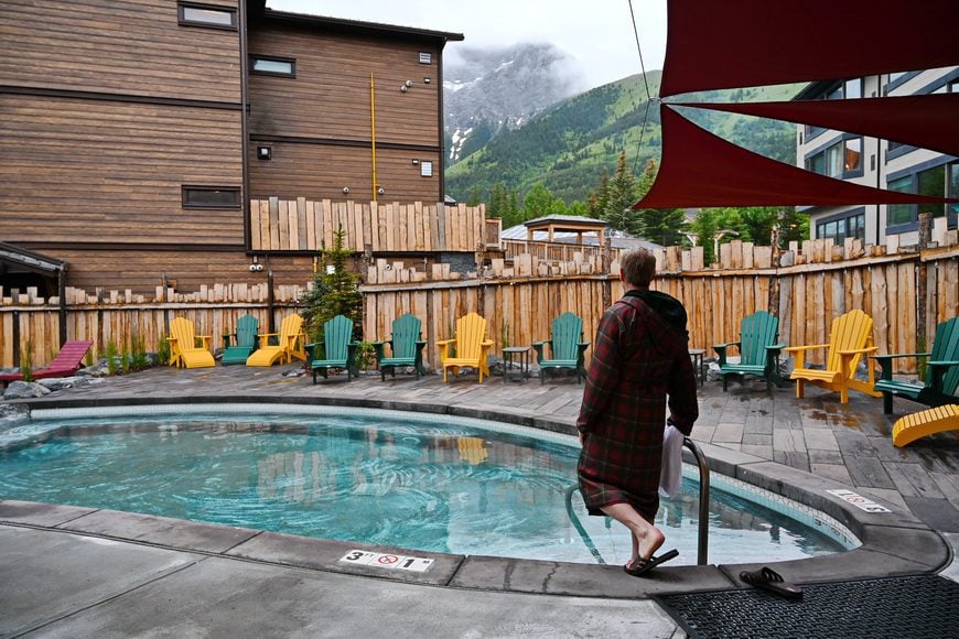 John testing the water temperature at the spa