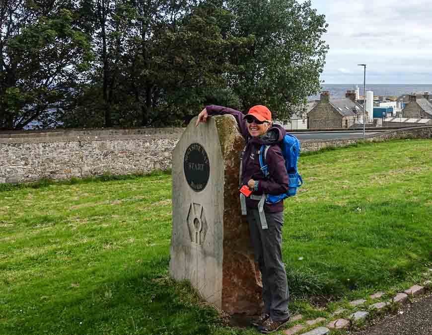 Susan at the Speyside Way trailhead with Buckie and the North Sea in the background. The representation of a thistle seen here marked our way