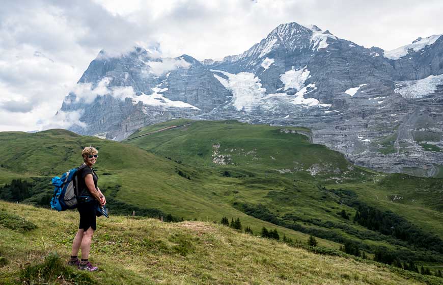 Woman drinking in the view of the Eiger on the Via Alpina in Switzerland