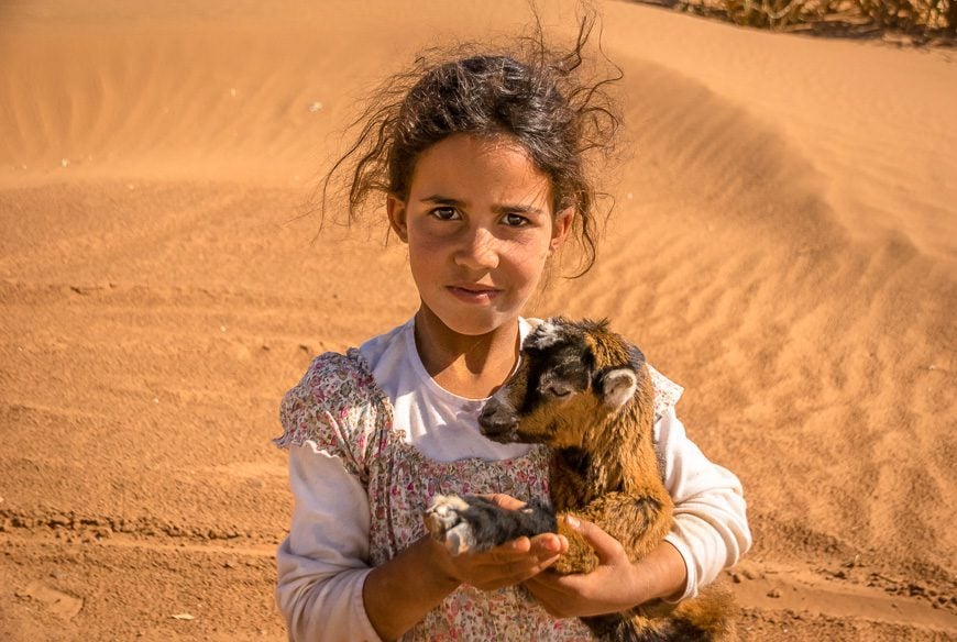 Young nomad girl with her goat