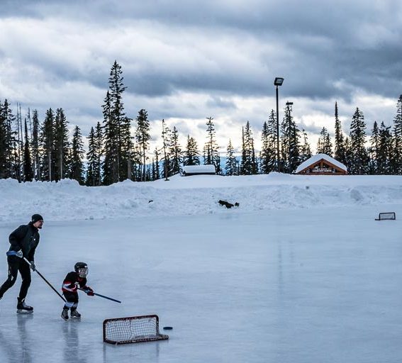 A father-son playing hockey at Big White