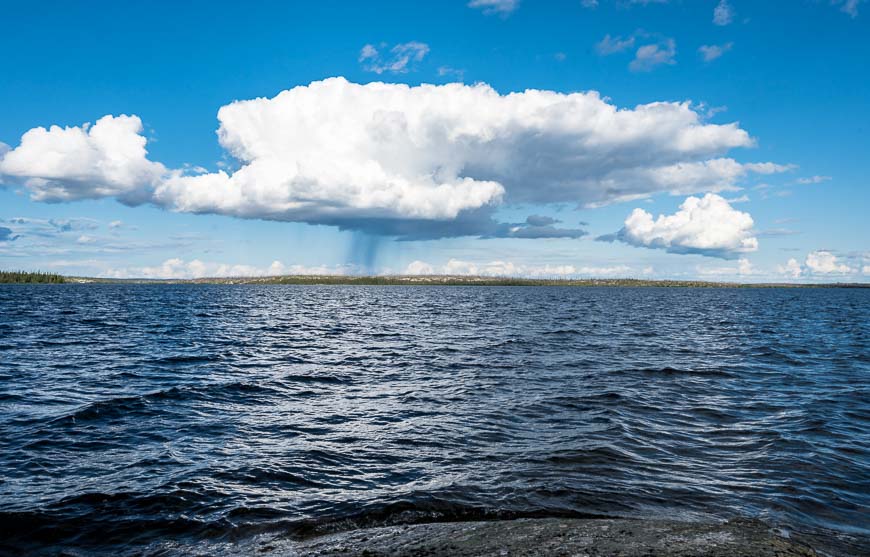 Enjoying the view of a rain shower from shore