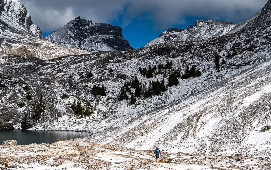 John hiking through snow on the way to the upper lake