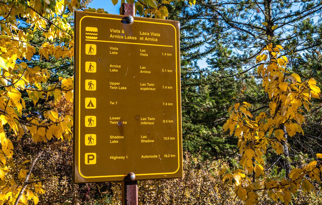 Trail signage by the parking lot that includes Arnica Lake