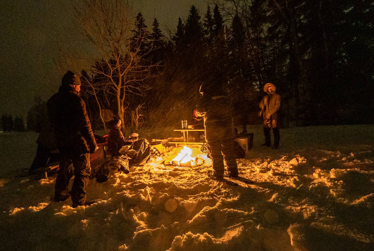 Enjoying a bonfire on a snowy night - but no stars