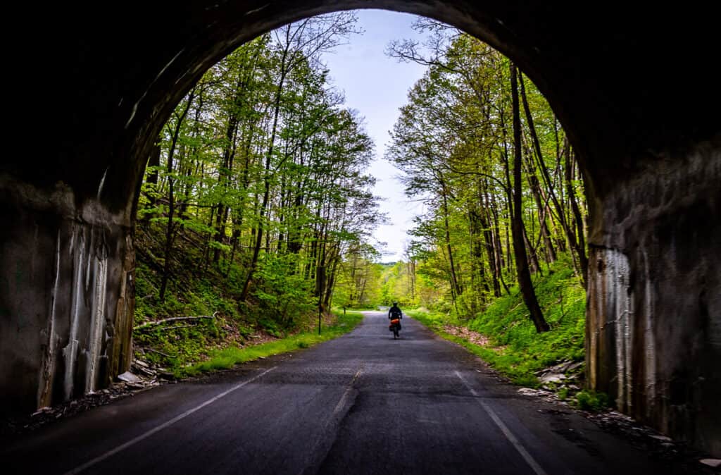 Cycling out of the Borden Tunnel on the Great Allegheny Passage bike ride