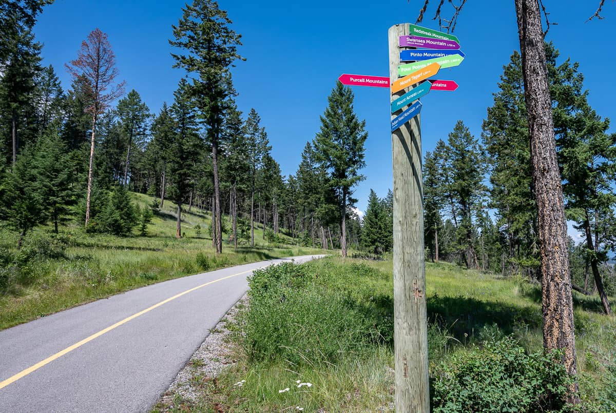 Colourful signage pointing to the mountains on the Westside Legacy Trail