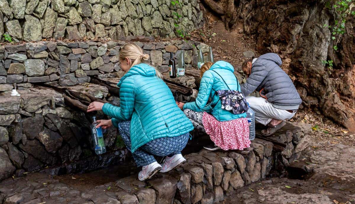 Filling water bottles at the fountains of Chorros de Epina