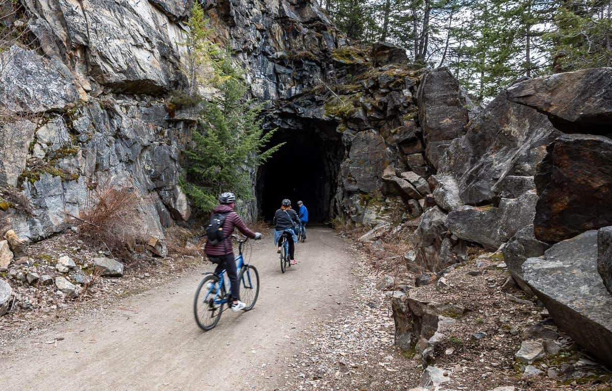 Biking into one of two tunnels on the Myra Canyon section of the KVR