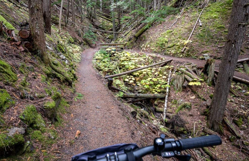 About 1.7 miles after leaving New Denver, hit the bike into a gully – take the upper trail on the far side