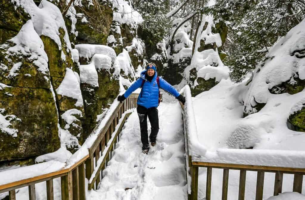 Me in the scenic gorge on a very snowy day in Mono Hills Provincial Park - one of the best places for  winter hikes in Ontario