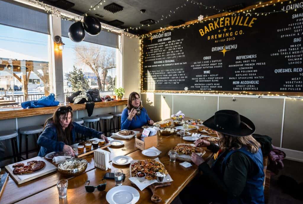 A flight of beers with delicious pizza and nachos at Barkerville Brewing