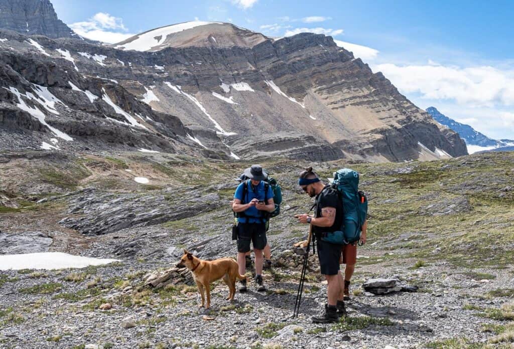 Stopping to check maps to be sure we're on the right track backpacking to Cataract Pass